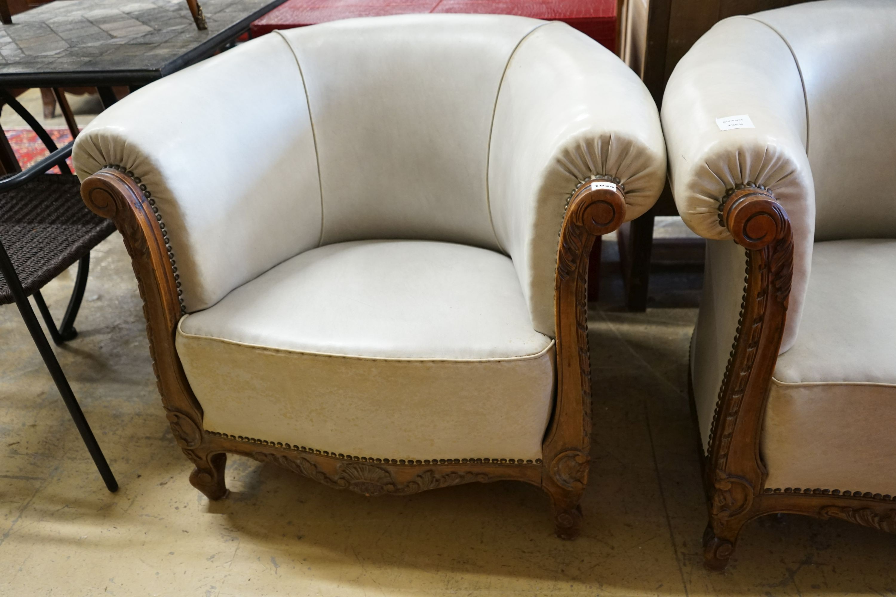 A pair of leather upholstered continental tub chairs, width 88cm, depth 70cm, height 72cm